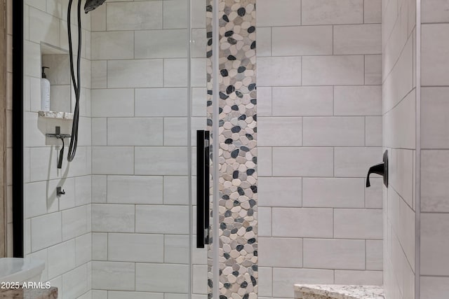 bathroom with a tile shower