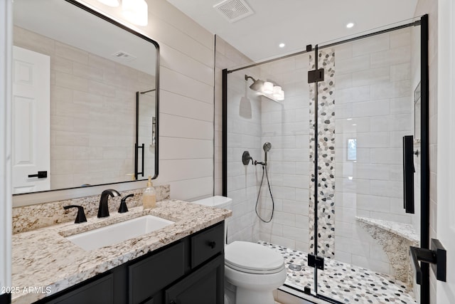 bathroom with vanity, toilet, and walk in shower