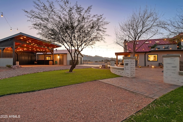 yard at dusk with a patio