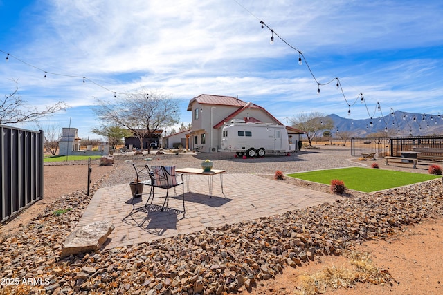 view of yard featuring a mountain view and a patio area