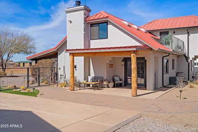 back of house with central AC and a patio area