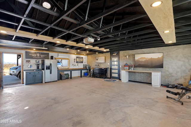 garage with stainless steel refrigerator with ice dispenser