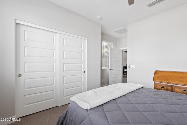 bedroom featuring carpet floors, visible vents, and a closet