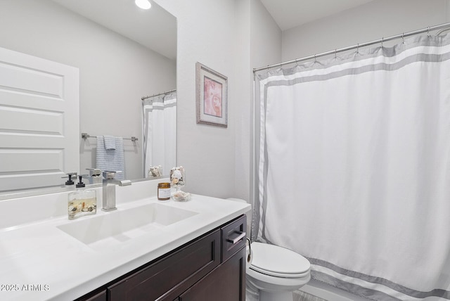 bathroom with vanity, curtained shower, and toilet