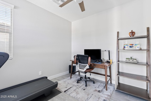 home office with baseboards, a ceiling fan, wood finished floors, and visible vents