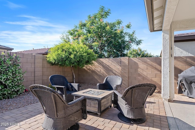view of patio / terrace featuring a fenced backyard, grilling area, and a fire pit