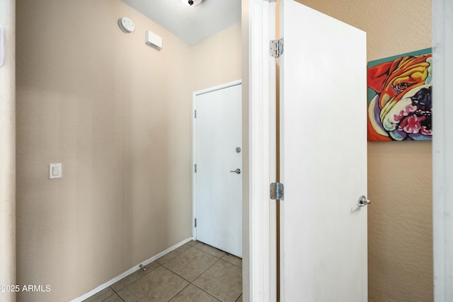 hall featuring light tile patterned flooring