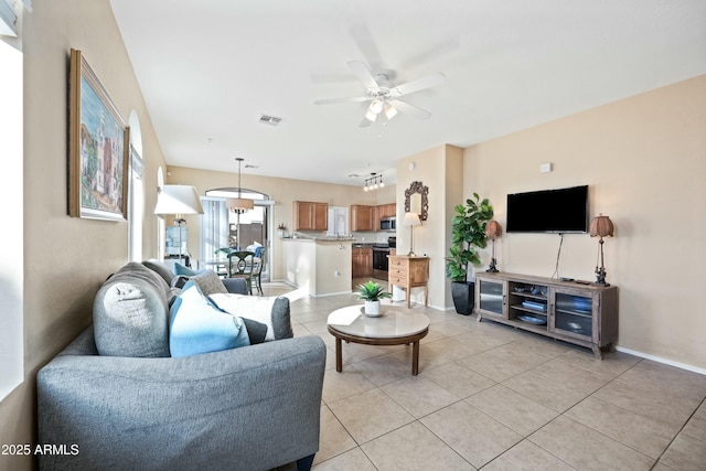 tiled living room with ceiling fan