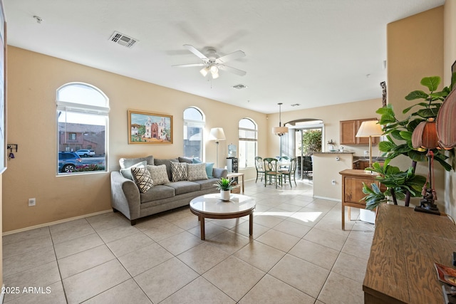 living room with light tile patterned floors and ceiling fan