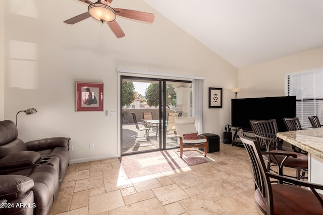 living room with ceiling fan and high vaulted ceiling