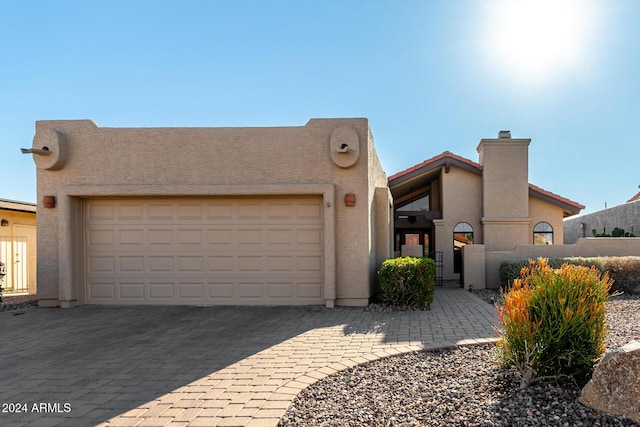 southwest-style home with a garage