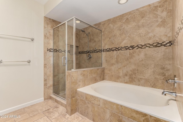 bathroom with separate shower and tub