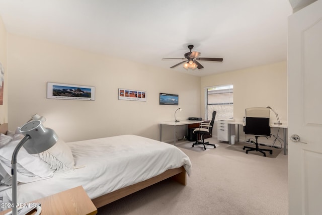 bedroom featuring light colored carpet and ceiling fan