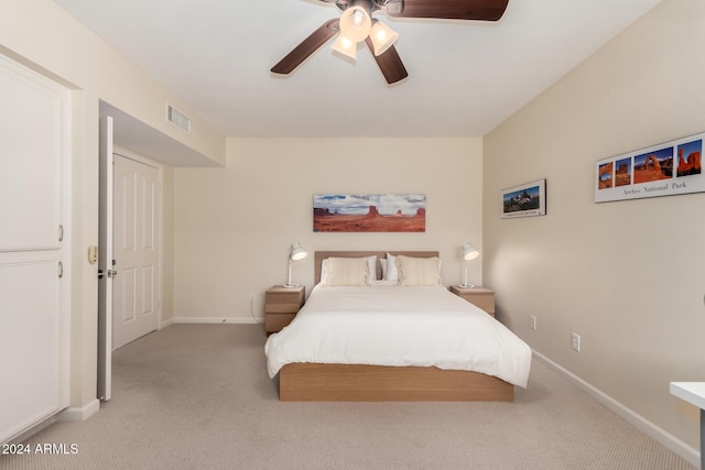 bedroom featuring light colored carpet and ceiling fan