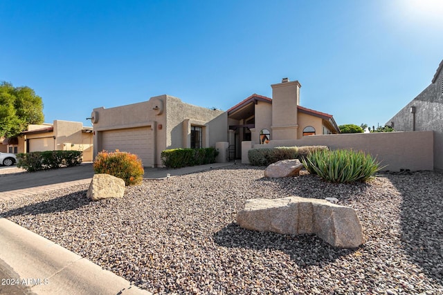 pueblo-style house with a garage