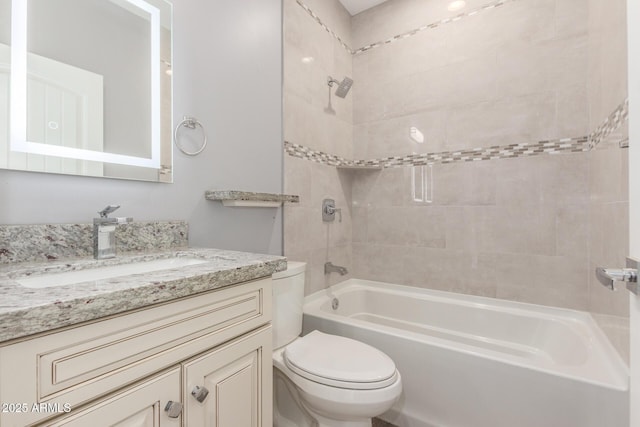 full bathroom with vanity, toilet, and tiled shower / bath