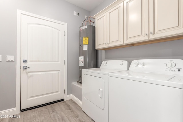 laundry room with cabinets, water heater, light hardwood / wood-style floors, and washer and dryer