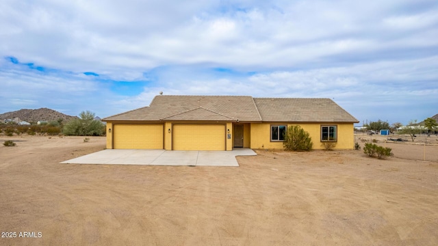 view of front of house with a garage and a mountain view