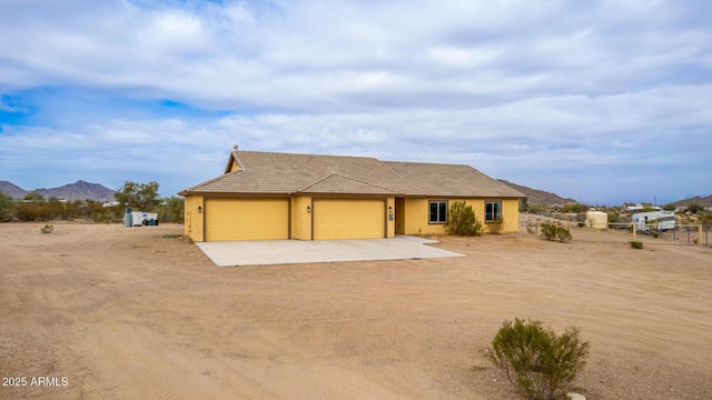 view of front of house featuring a garage and a mountain view