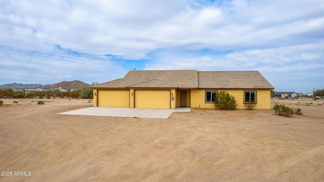 view of front of home featuring a garage and a mountain view