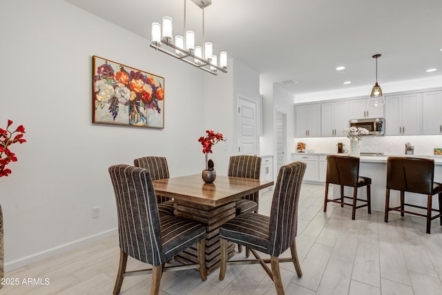 dining room featuring a chandelier and light wood-type flooring