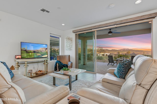 living room with ceiling fan and a wealth of natural light