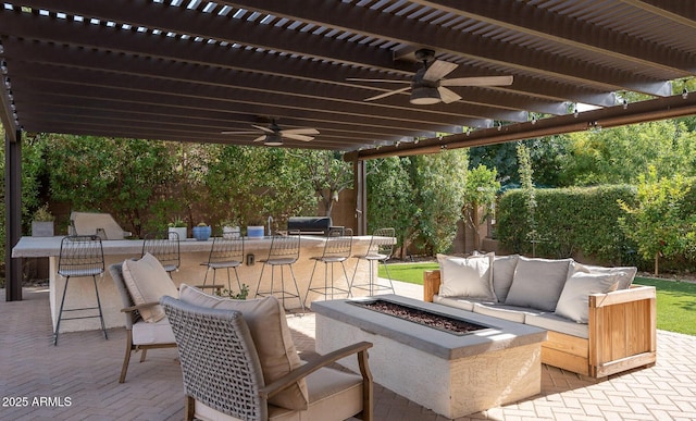 view of patio / terrace featuring a ceiling fan, an outdoor living space with a fire pit, and a pergola