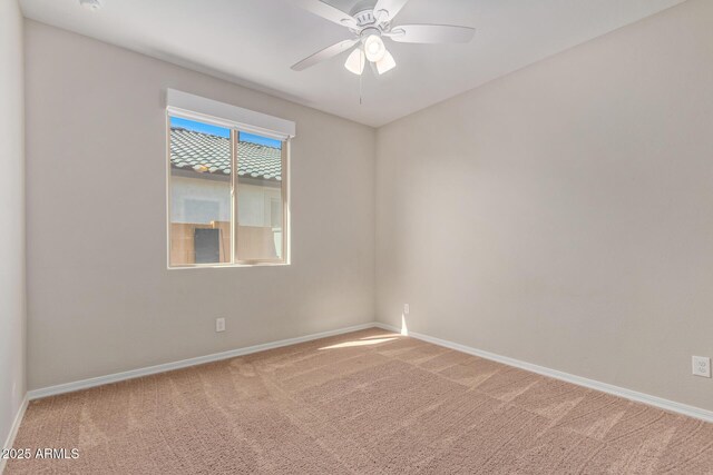 unfurnished room featuring carpet, baseboards, and a ceiling fan