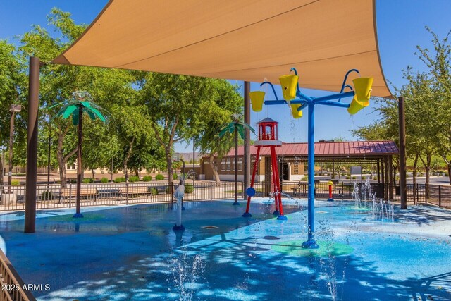 view of jungle gym featuring fence