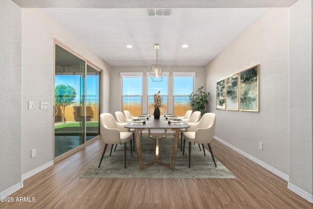 dining room with recessed lighting, visible vents, baseboards, and wood finished floors