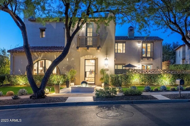 mediterranean / spanish-style house with a balcony