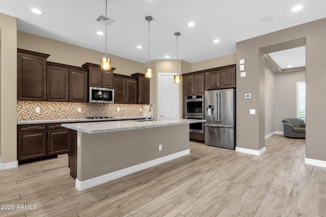 10350 E Texas Ave, Mesa, AZ 85212 - kitchen featuring stainless steel appliances, light wood-style floors, dark brown cabinets, and recessed lighting
