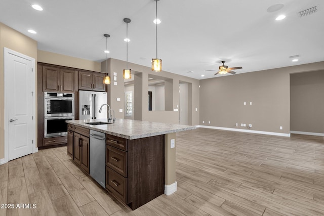 10350 E Texas Ave, Mesa, AZ 85212 - kitchen featuring stainless steel appliances, a sink, light countertops, light wood-style floors, and a ceiling fan