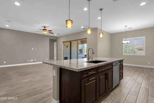 10350 E Texas Ave, Mesa, AZ 85212 - kitchen with a sink, light wood finished floors, baseboards, stainless steel dishwasher, and open floor plan