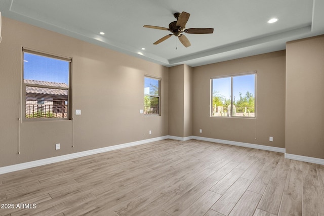 10350 E Texas Ave, Mesa, AZ 85212 - empty room with plenty of natural light, light wood-style floors, ceiling fan, a tray ceiling, and recessed lighting