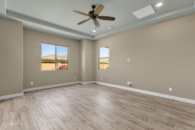 10350 E Texas Ave, Mesa, AZ 85212 - unfurnished room with light wood-style flooring, a tray ceiling, a ceiling fan, recessed lighting, and baseboards
