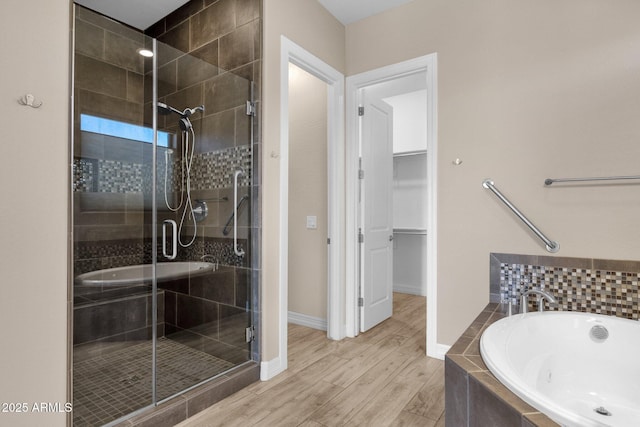 10350 E Texas Ave, Mesa, AZ 85212 - bathroom featuring a stall shower, a spacious closet, a garden tub, wood finished floors, and a sink