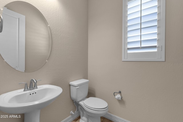 10350 E Texas Ave, Mesa, AZ 85212 - bathroom featuring a sink, baseboards, and toilet