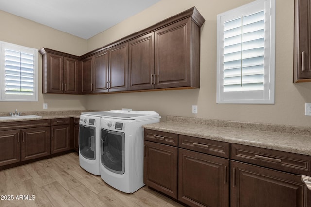 10350 E Texas Ave, Mesa, AZ 85212 - laundry room featuring washing machine and dryer, cabinet space, and light wood finished floors