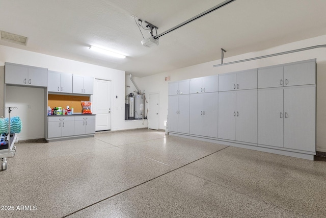 10350 E Texas Ave, Mesa, AZ 85212 - garage featuring gas water heater, a garage door opener, and baseboards