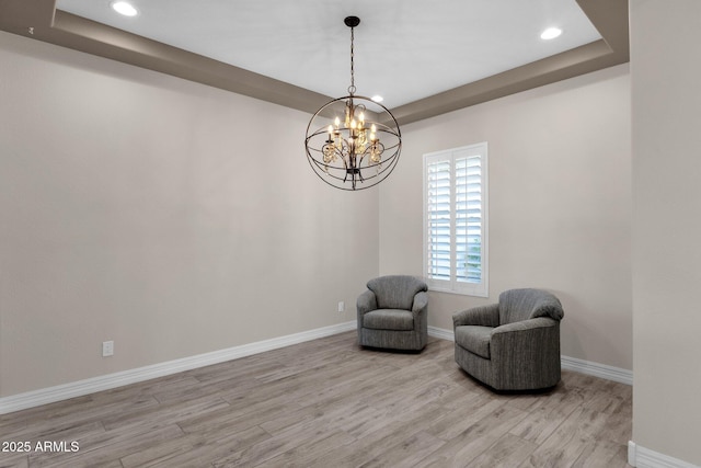 10350 E Texas Ave, Mesa, AZ 85212 - living area featuring wood finished floors, baseboards, a raised ceiling, recessed lighting, and a chandelier