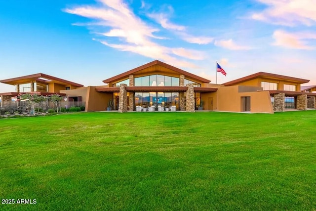 10350 E Texas Ave, Mesa, AZ 85212 - rear view of property featuring stone siding and a yard
