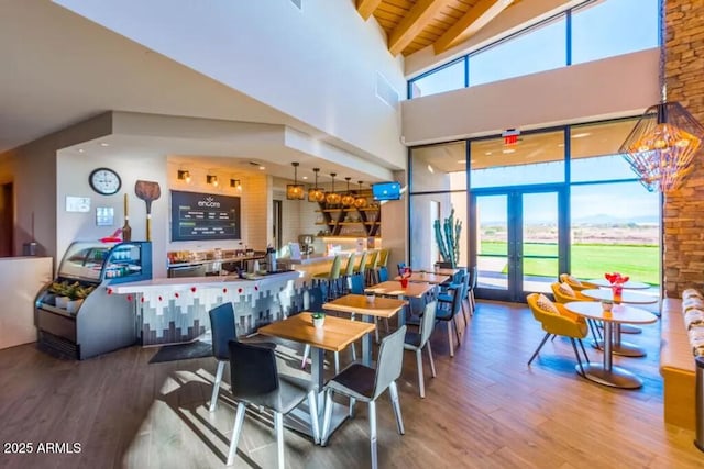 10350 E Texas Ave, Mesa, AZ 85212 - dining area featuring a towering ceiling, wood finished floors, healthy amount of natural light, and french doors