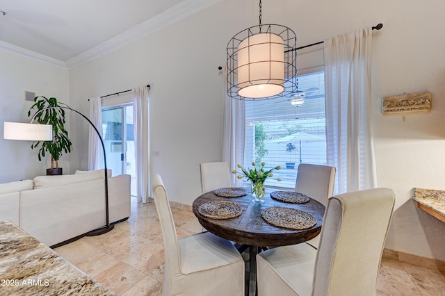 dining space featuring crown molding, healthy amount of natural light, and baseboards