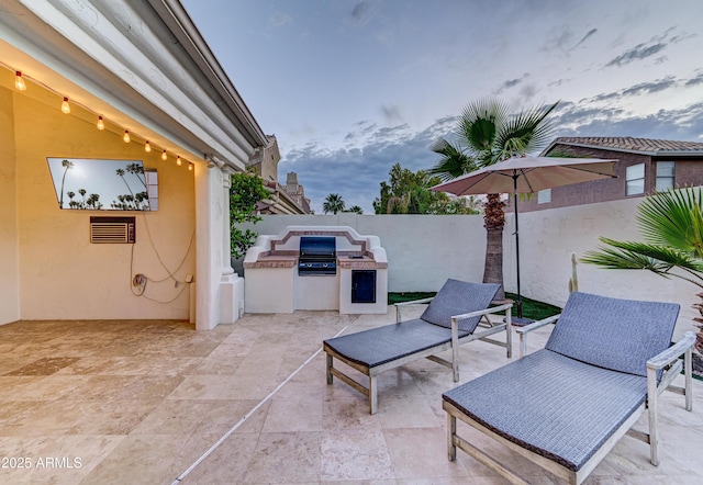 view of patio / terrace featuring area for grilling and fence
