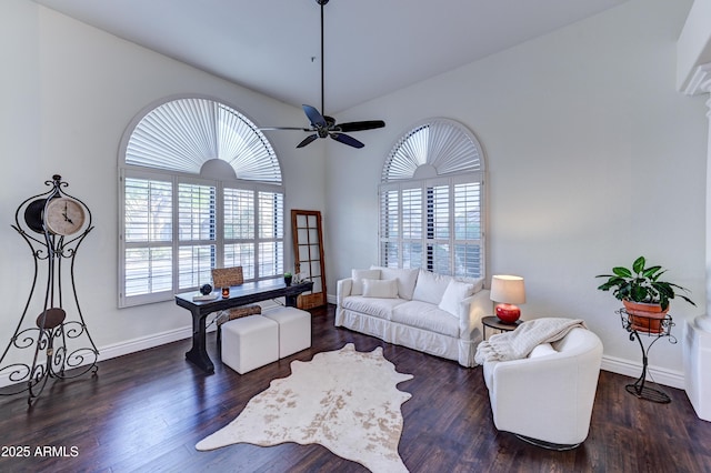 living room with healthy amount of natural light, a ceiling fan, wood finished floors, and vaulted ceiling