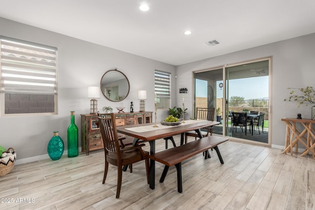 dining space with light hardwood / wood-style flooring