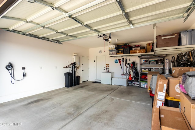 garage with a garage door opener and tankless water heater