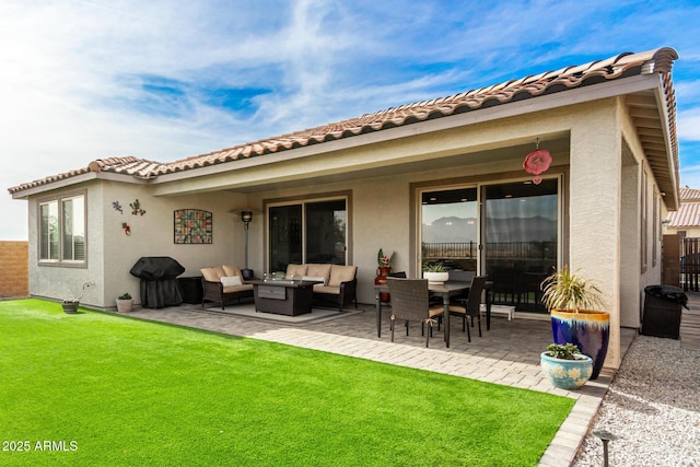 back of house featuring an outdoor living space, a lawn, and a patio