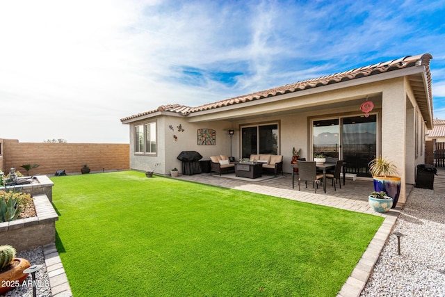 rear view of house featuring a yard, an outdoor hangout area, and a patio area